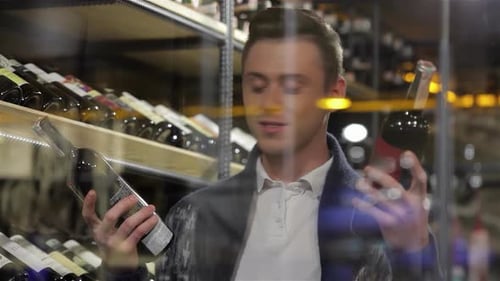 Man in a Supermarket Comparing Two Wines