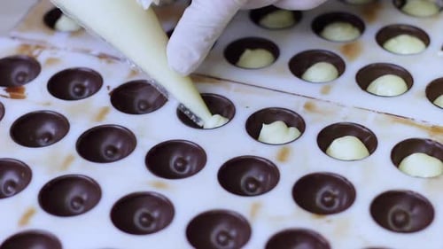 Filling Chocolate Mold with Cream in Kitchen