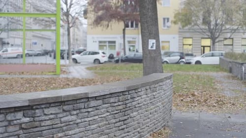 Man Jumps Over Brick Wall in City