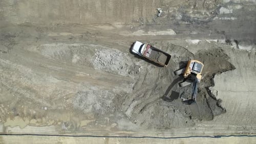 Excavator Filling Dump Truck Aerial Shot