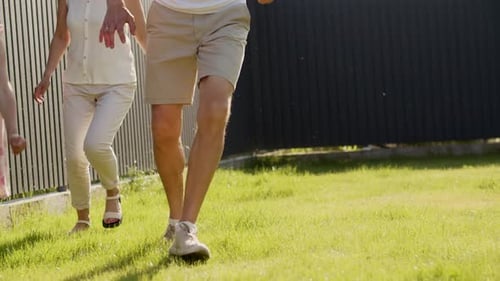 American Dream Family Run on the Lawn and Play Outdoors Near Their House Mom Dad and Daughter Relax
