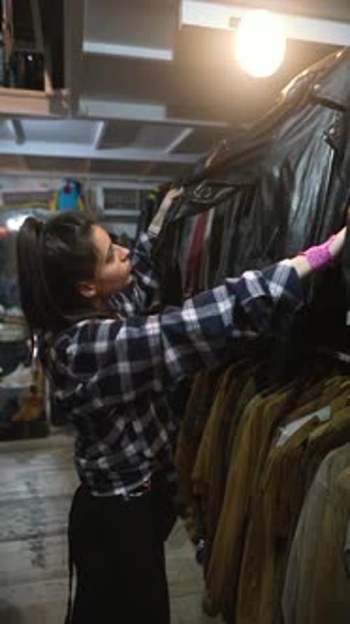 Young Woman Browsing Clothing in a Store