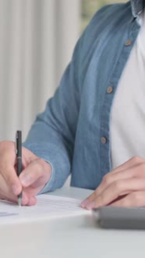 Close Up of Male making Calculations, Writing on Paper, Vertical Video