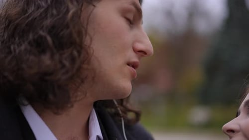 Young Couple Listens to Music Together on Earbuds