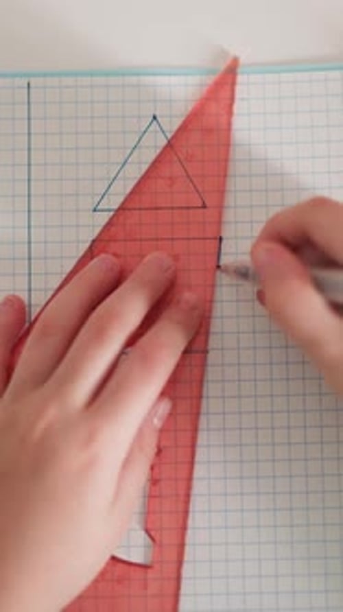 Little Student Draws Geometrical Shape on Exercise Book Page