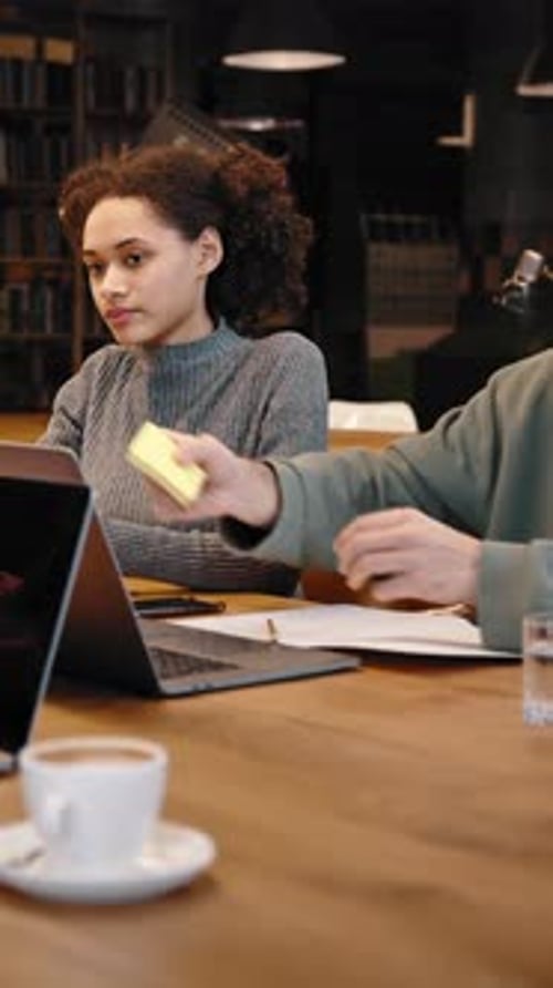 Young Lady Coach Gives Sticky Notes to Young People Interns