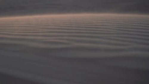 Wind Moving Sand Above Surface of Dunes Deep in Desert, Close Up