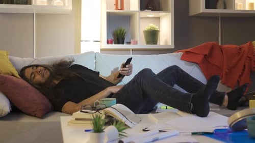 Man Relaxes on Couch with Remote Control