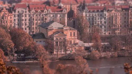 One of the historic buildings on the banks of the Vltava river in Prague. The boats are parked on th
