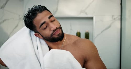 Attractive Man Toweling Hair in Modern Bathroom