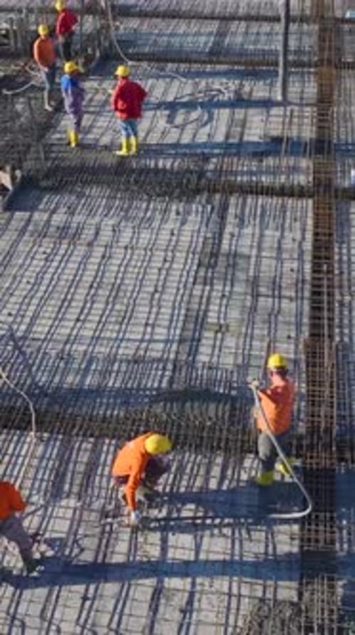Vertical Video of a House Undergoing Major Structural Work With Builders Installing Metal Beams and