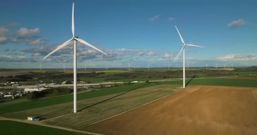 Large White Power Generators That Generate Electricity From the Wind Wind Turbines in a Field