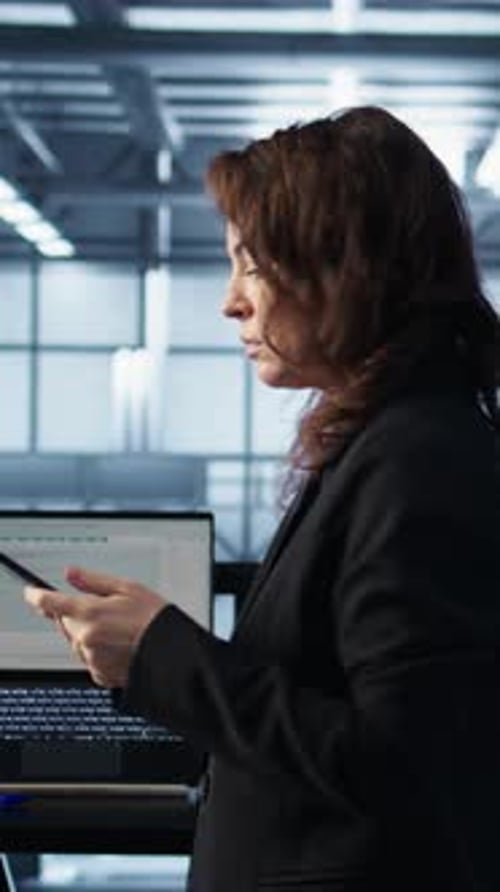 Vertical Video Technician in Data Center Using AI Tech on Tablet