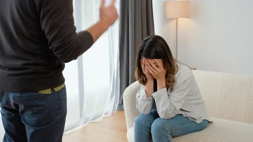 Upset Woman Crying on Couch with Man