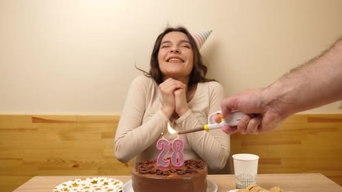 Woman Celebrates Birthday Blowing Out Cake Candles