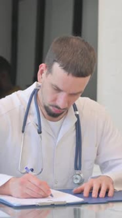 Doctor Discussing Medical Report with Patient in Clinic, vertical video