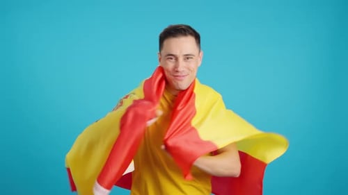 Young Man Wrapped in Spanish Flag Celebrates