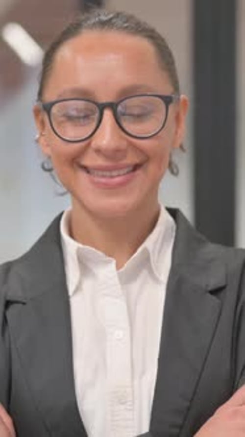 Portrait of Smiling Hispanic Business Woman in Office, vertical video