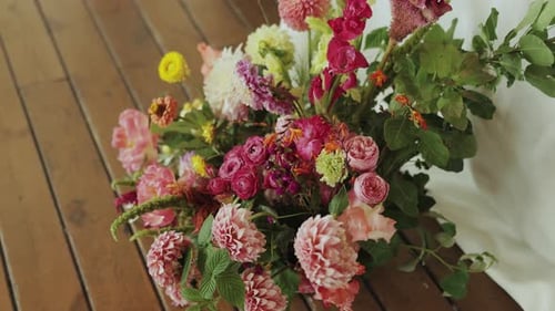 A Colorful and Vibrant Floral Arrangement Displayed on a Beautiful Natural Wood Surface