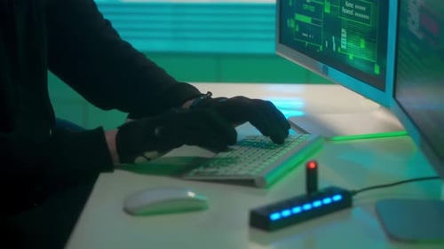 Hacker is Typing on a Computer Keyboard Cracking a Password Copies the Information to a Flash Drive