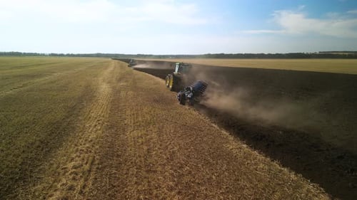 Tractors plowing the field in Ukraine