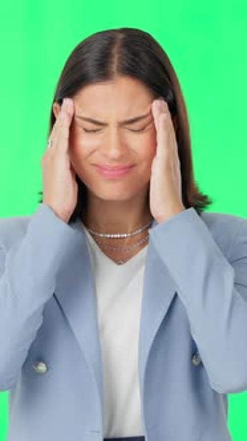 Business, green screen and woman with headache, pain and brain fog on studio background