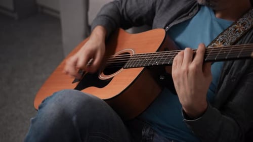 Man Playing Acoustic Guitar Closeup Guitar Deck and Musician's Hand Wooden