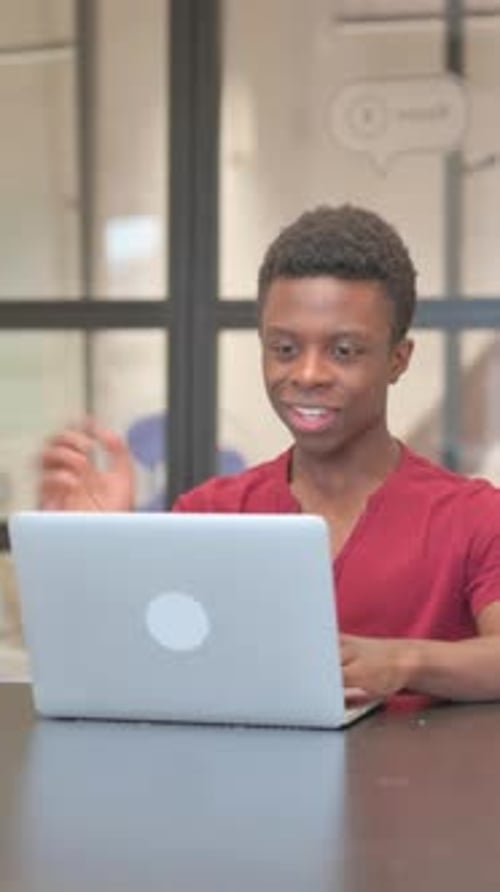 Young Adult Using Laptop for Video Call