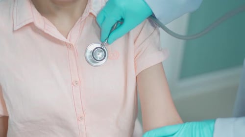 Doctor Examining Patient with Stethoscope in Hospital