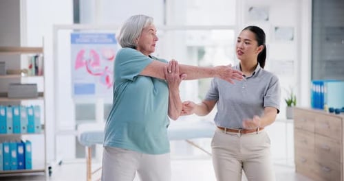 Physical Therapist Helping Senior Woman with Arm Stretch