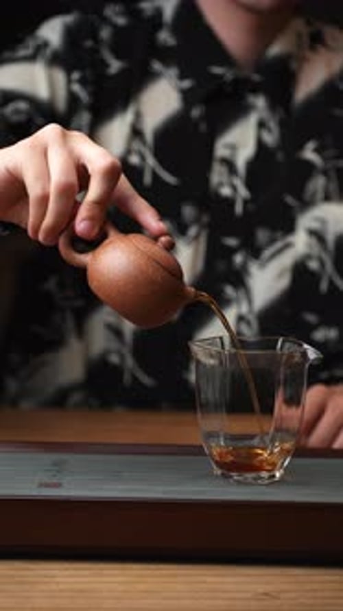 Teapot Pouring Into Clear Glass Close Up