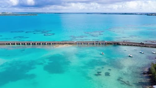 Aerial hyperlapse of car bridge over turquoise water on tropical island. MOVING FORWARD.