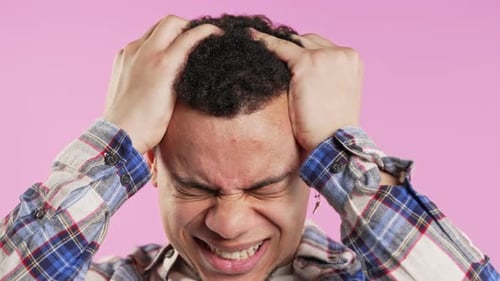 Young Man Having Headache Pink Studio Portrait Ill Guy Puts Hands on Head