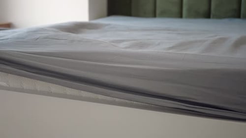 Making a Bed with Fresh Linen and a Smooth Mattress Cover