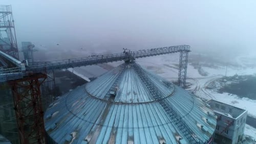 Winter Aerial of Rural Grain Elevator and Birds