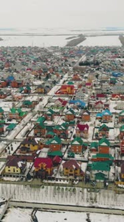 Cottage Complex with Colorful Houses Against Snow Field