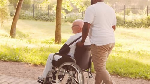 AfricanAmerican Caregiver and Old Man Professional Nurse and Patient in a Nursing Home Assistance