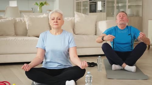Senior Couple Meditating at Home Together