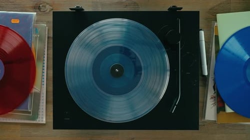 Placing Vinyl Record on Turntable Overhead Shot