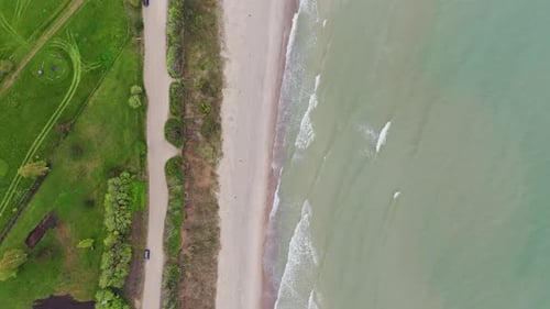 Aerial Top View of Gentle Ocean Waves Crashing on Beach