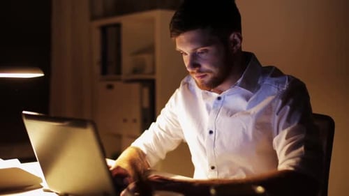 Man Works at Desk Late at Night