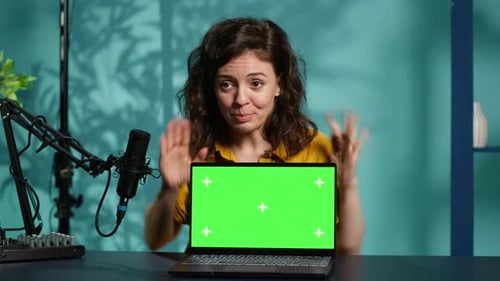 Woman with Laptop with Green Screen Speaking to Camera