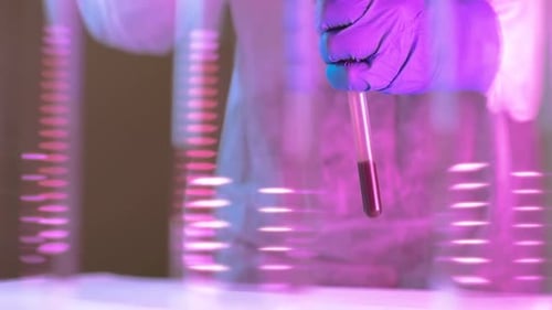 Medical Researcher Holding Test Tube with Blood Sample