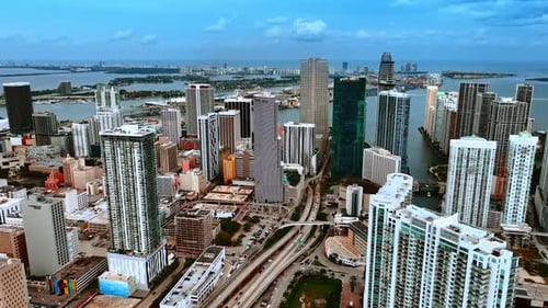 Rising above the beautiful modern city panorama on grey cloudy day. Top view of Miami, Florida.