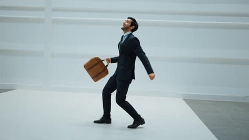 Manager dancing to celebrate success project while moving to music.Exultant.