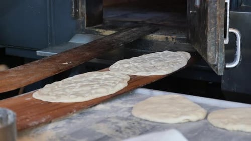 the Chef's Hands Form a Round Pizza Base From the Dough with His Hands