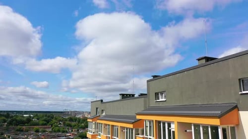 Modern architecture in the city. Tall building with grey roof in the city. New residential apartment