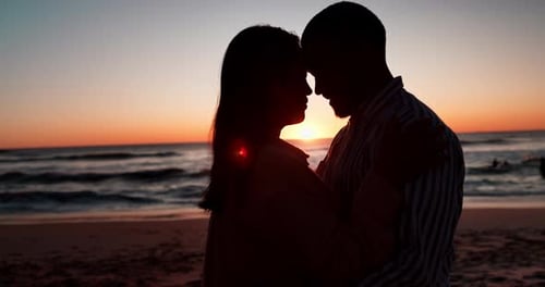 Sunset, beach and couple with love, silhouette and vacation with anniversary, romance and travel