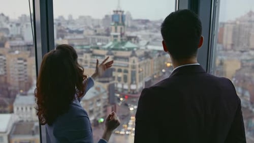 Two Architects Looking City View Standing at Window High Office Building Closeup