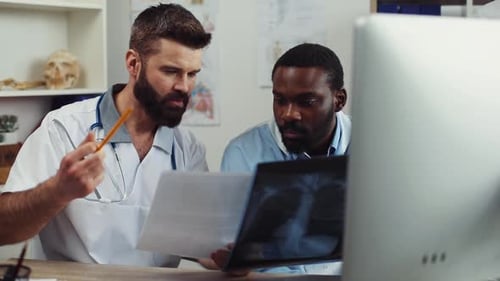 Two Doctors Reviewing X-Ray Together in an Office